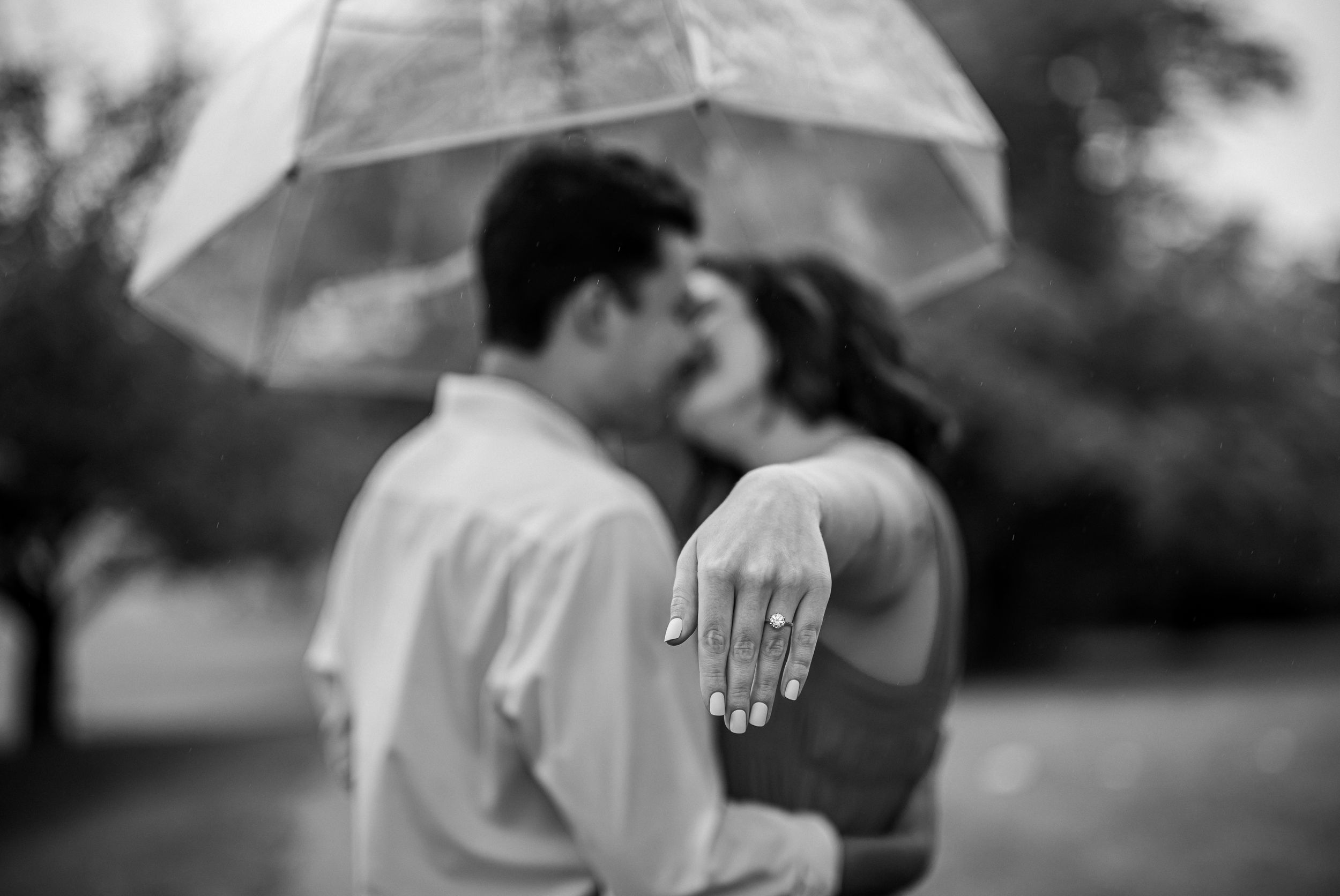 Black and white photo series capturing romantic moments between a couple embracing in various outdoor settings.