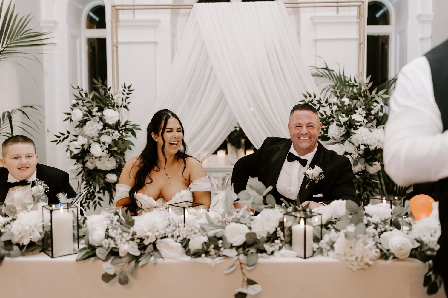 A wedding ceremony takes place in a gothic cathedral with ornate stained glass windows and vaulted arches.