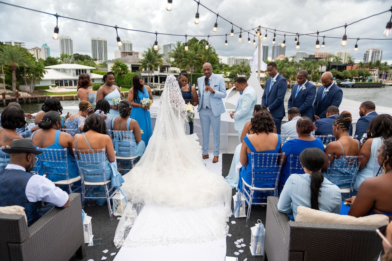 The officiant prays with the couple during the ceremony on the Sun Dream Yacht Caprice, captured by Luxury wedding photographers in Florida
