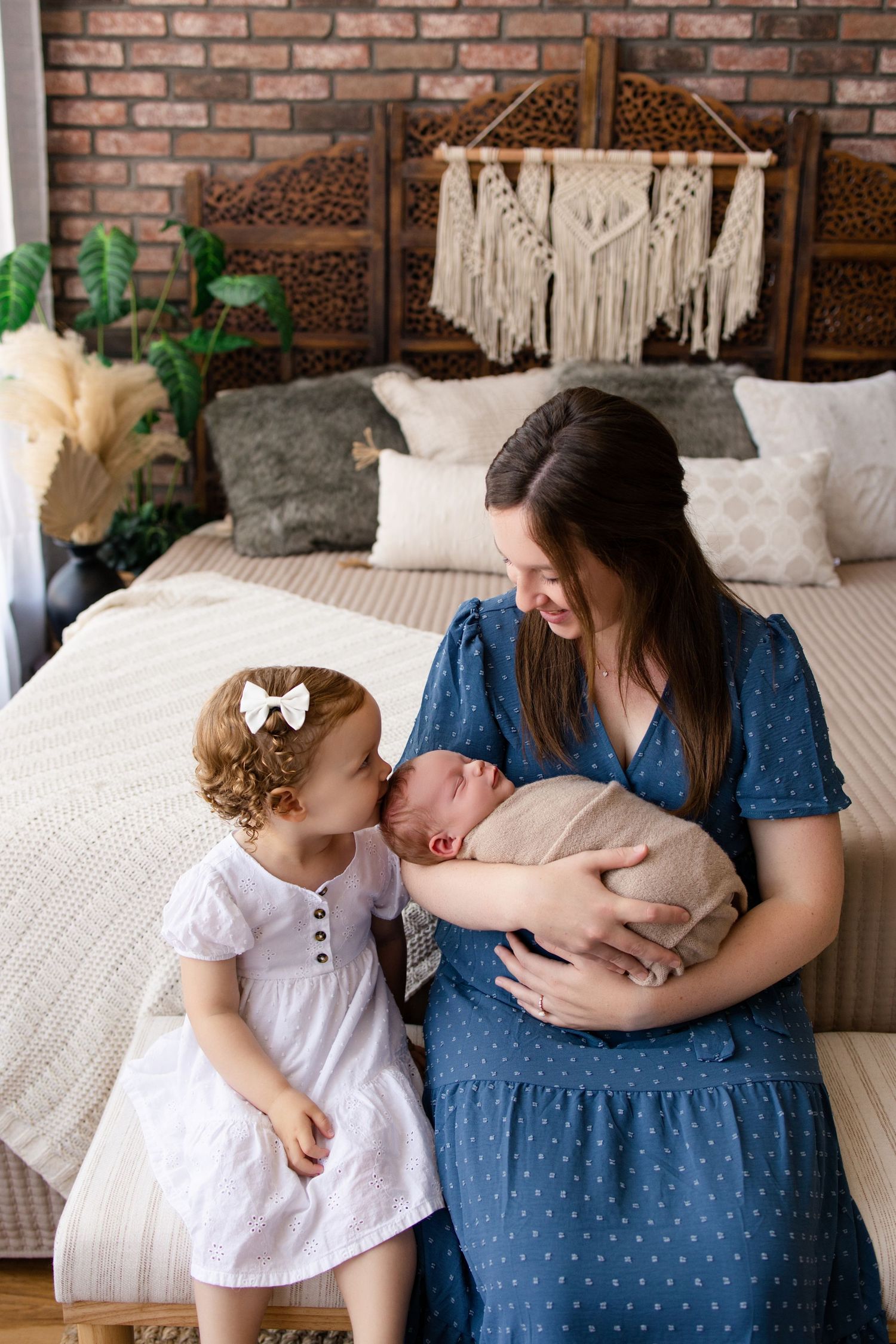 Three heartwarming photos show tender moments shared between family members on a cozy bed with decorative pillows.