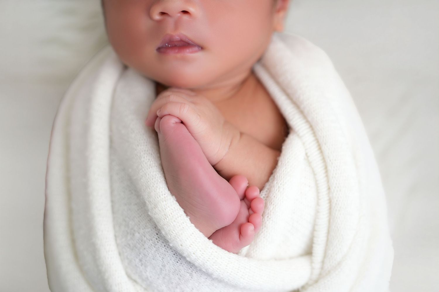 New born photographer Dubai capturing peaceful sleeping baby in a studio setup