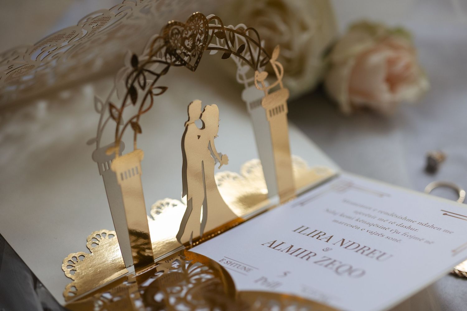 Romantic couple shares their first dance under twinkling lights at an elegant ballroom wedding reception.