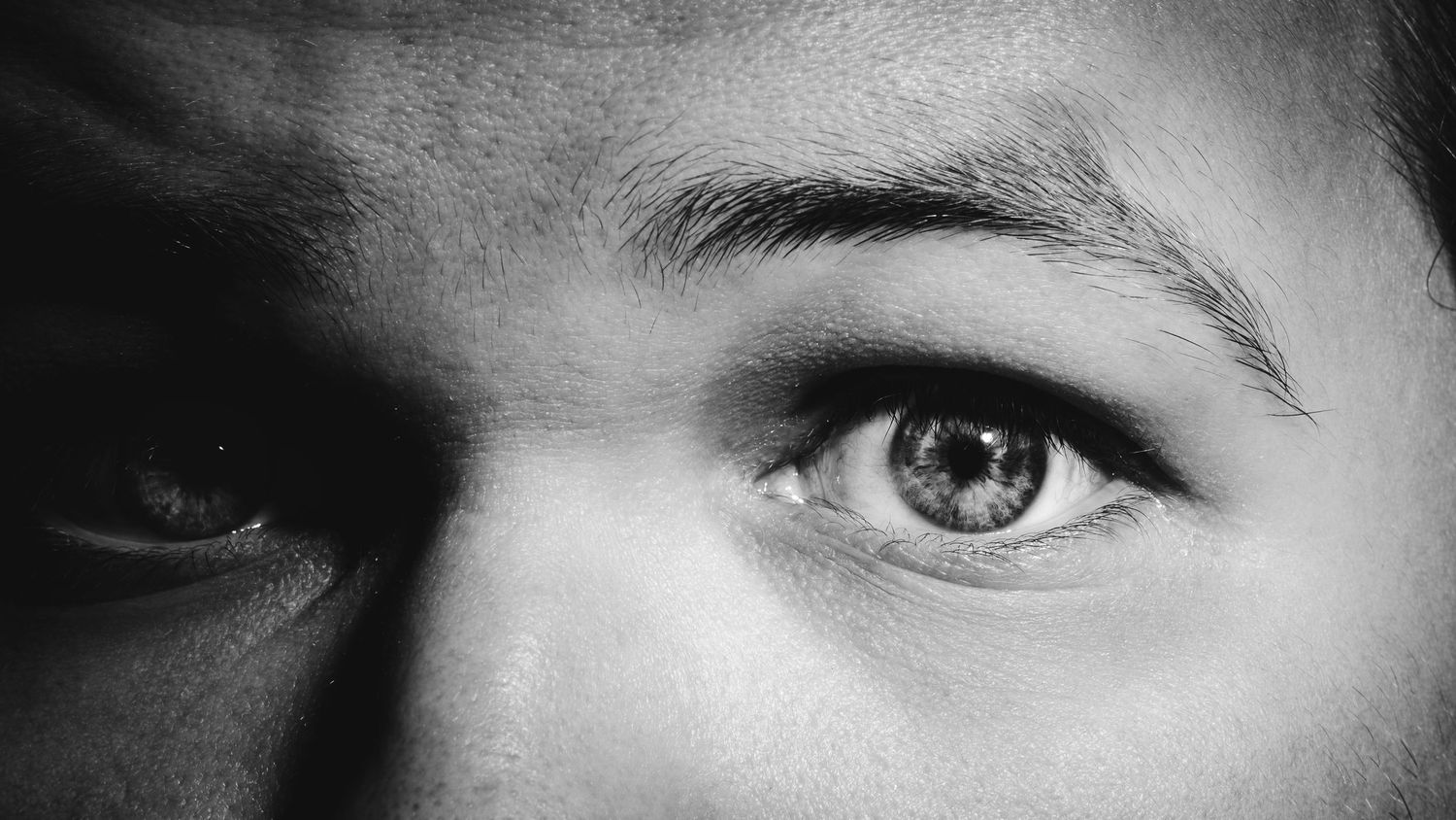 A series of black and white close-up shots showing different angles of a Fujifilm camera against a dark background.