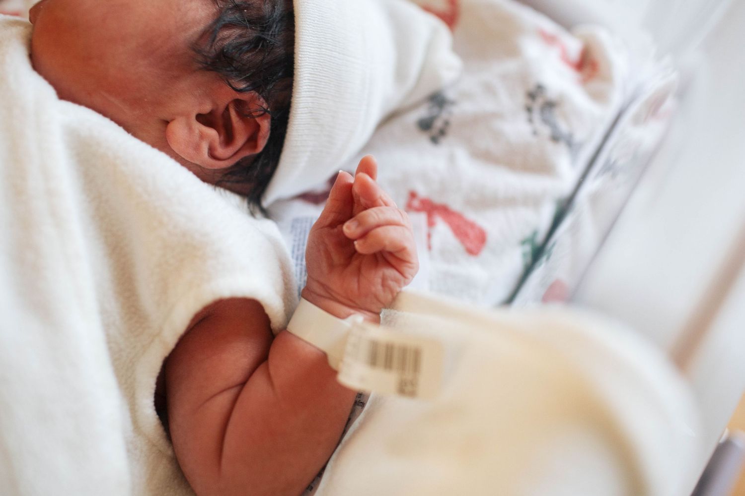 A close-up photo of a newborn baby laying on the hospital blanket during a Fresh 48 session in Seattle WA