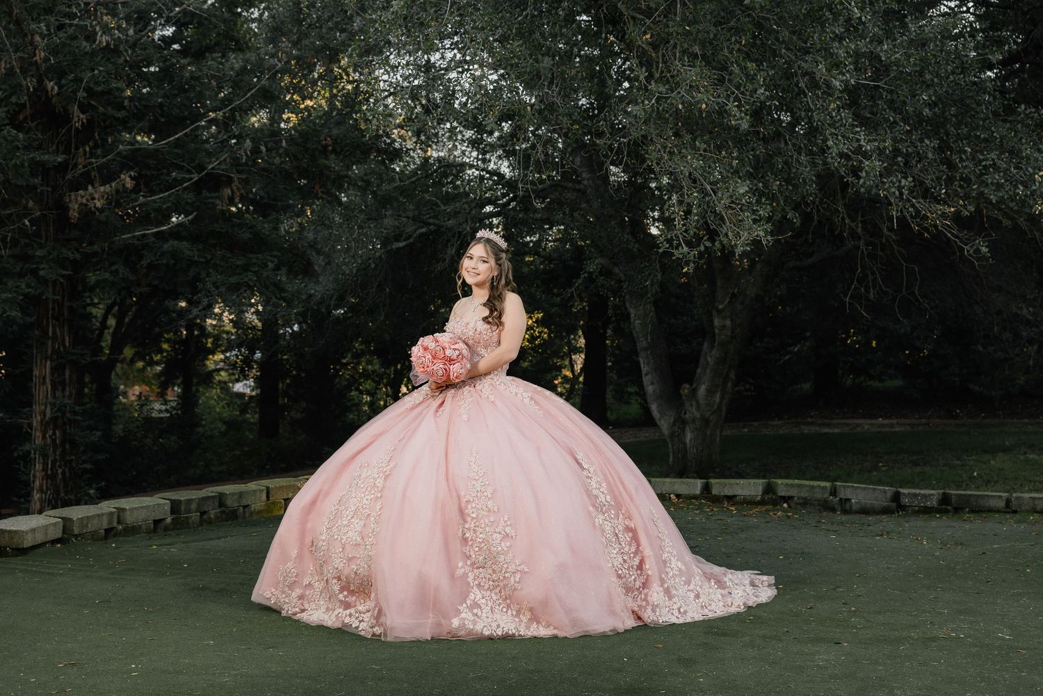 A light green dress flows elegantly on a tree-lined path with the State Capitol building visible in the background for Sacramento quince