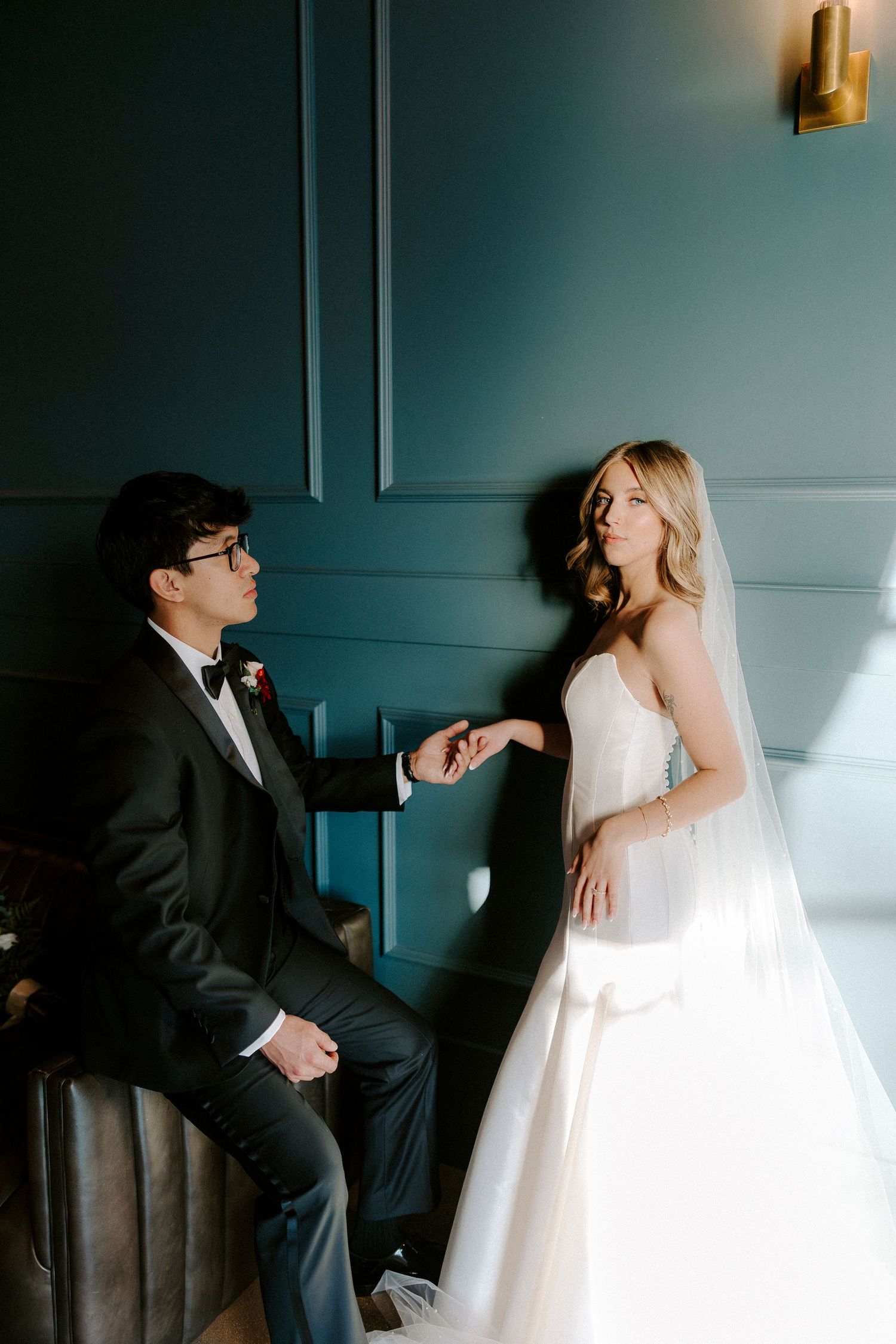 A sequence of wedding photos showing intimate moments between a couple in formal attire against a dark teal wall.