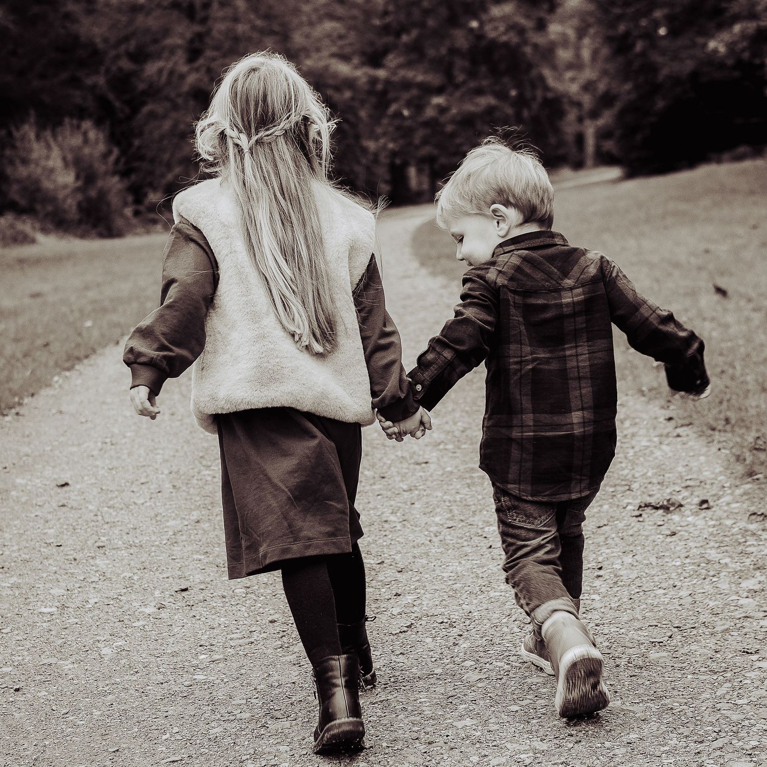 Two children running away during a preschool photo shoot.