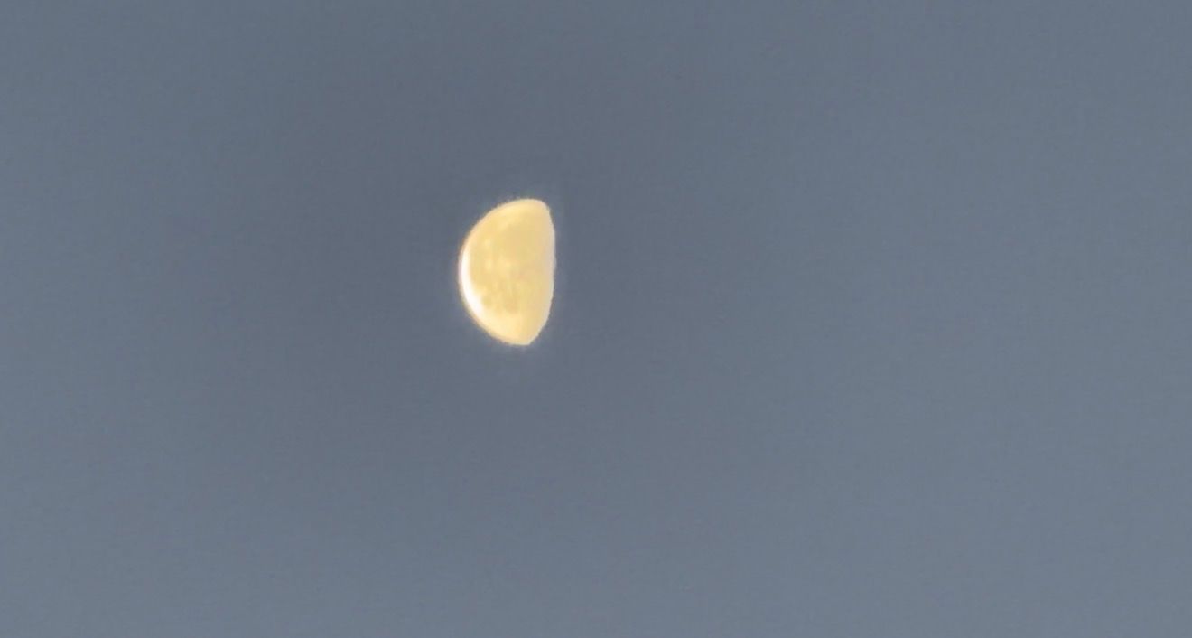 A series of photos showing the moon in different phases against a dark blue evening sky.