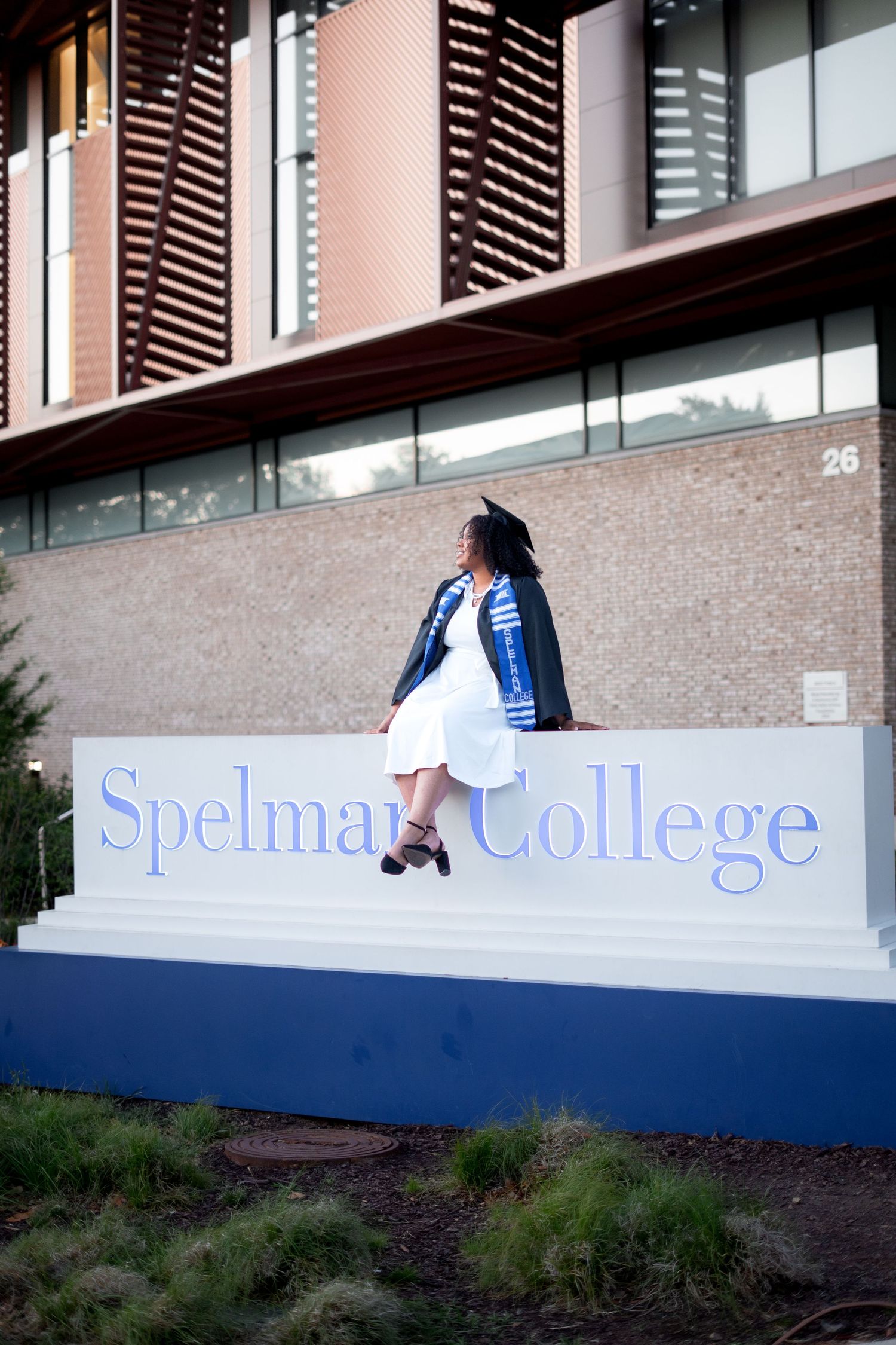 Spelman graduation photos in front of the iconic sign