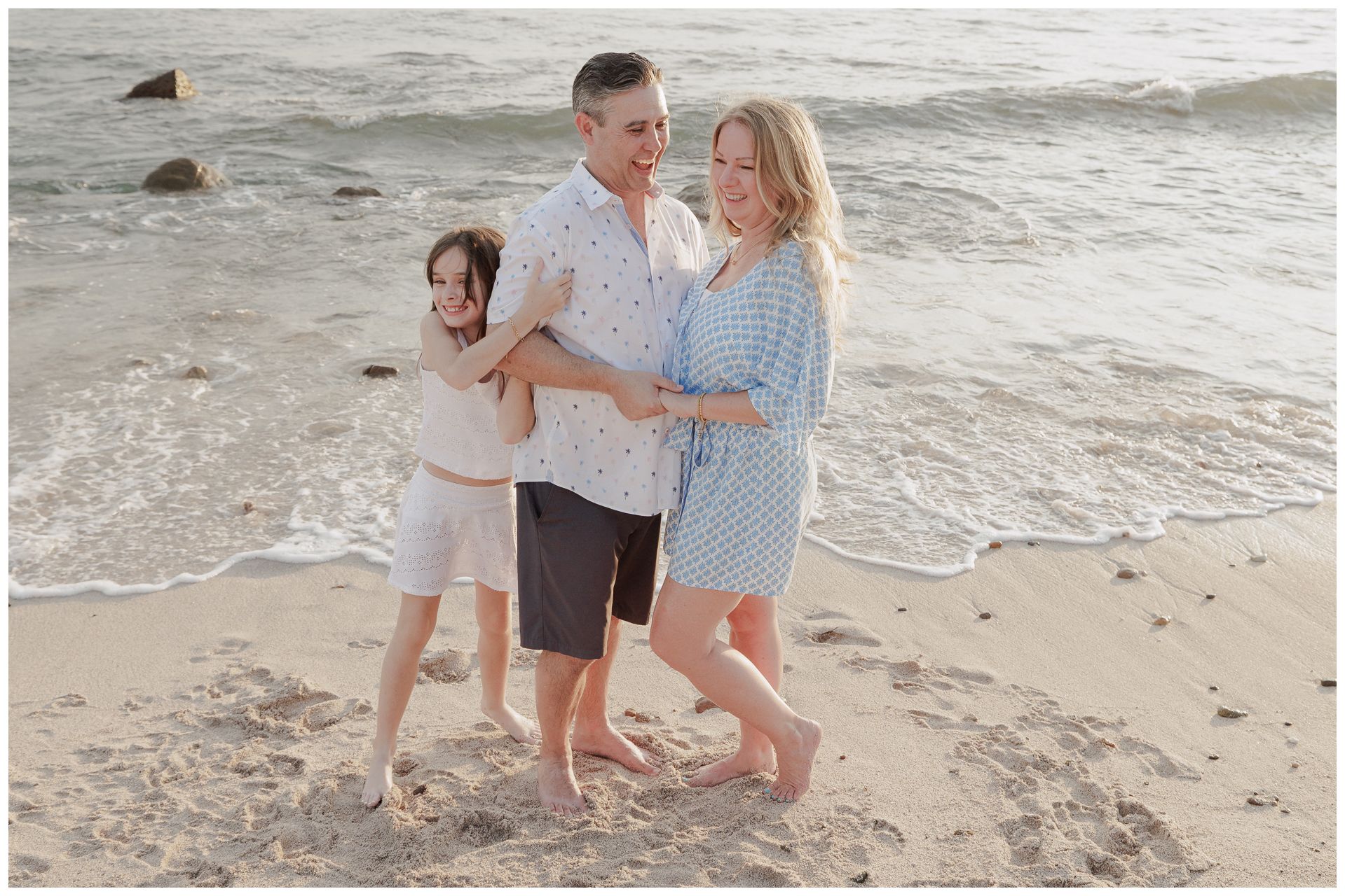 St. Regis Punta Mita family photographer creating beach family photos with genuine laughter by the ocean at golden hour.