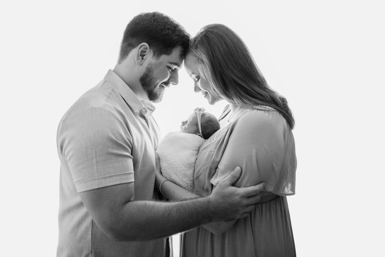 New parents holding newborn during Tampa newborn photos
