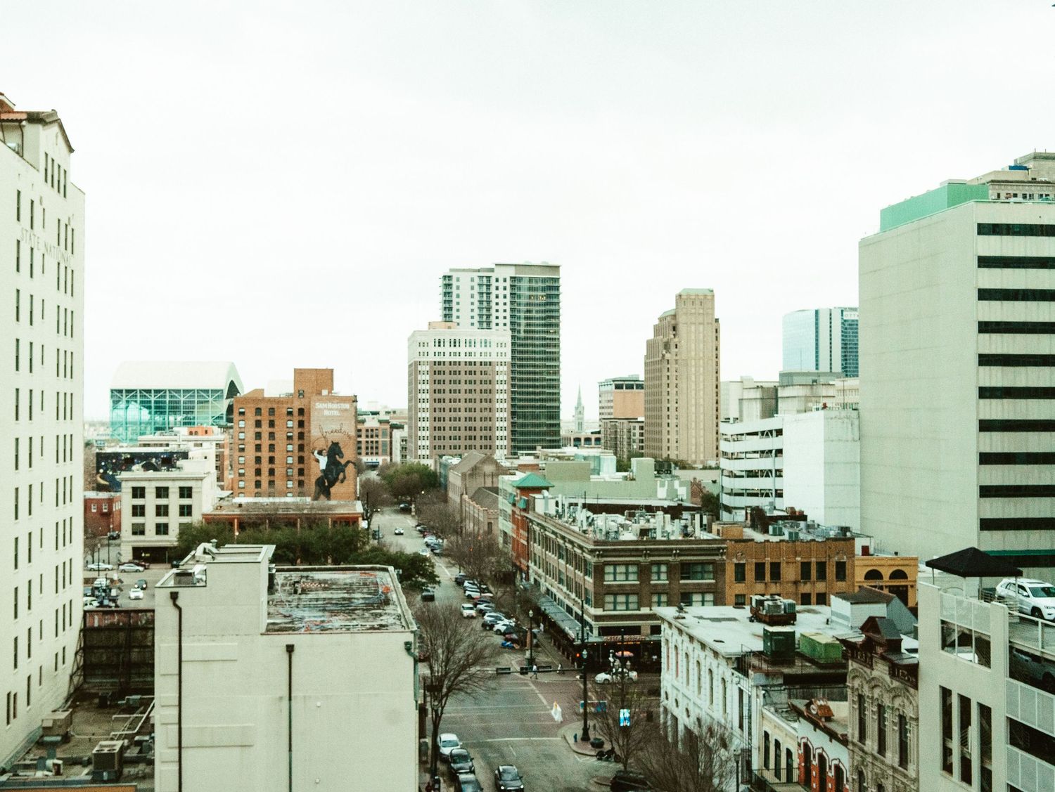 Aerial cityscape view of downtown Sacramento with historic buildings and modern skyscrapers along a main street.