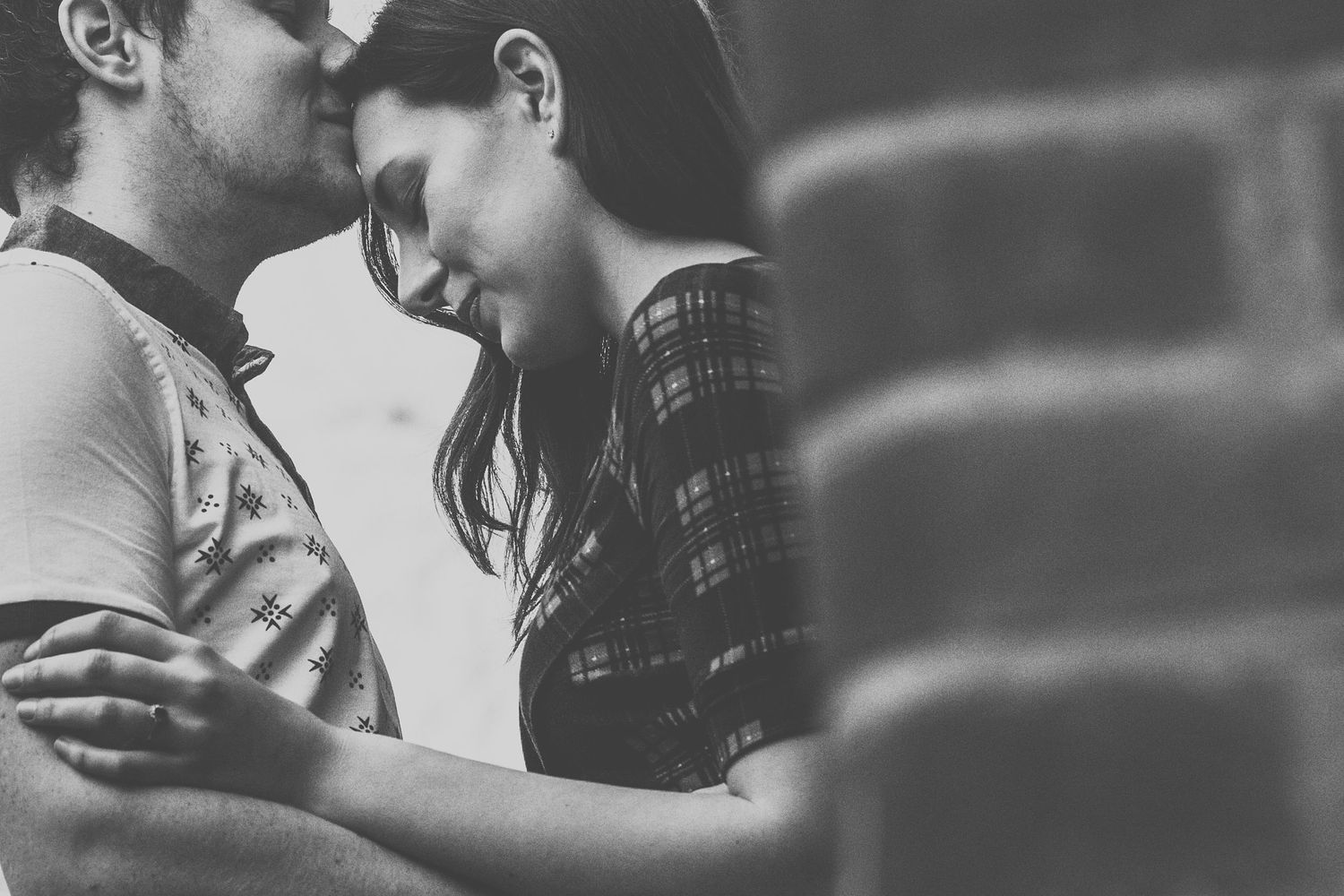 Black and white intimate portrait of a couple embracing.