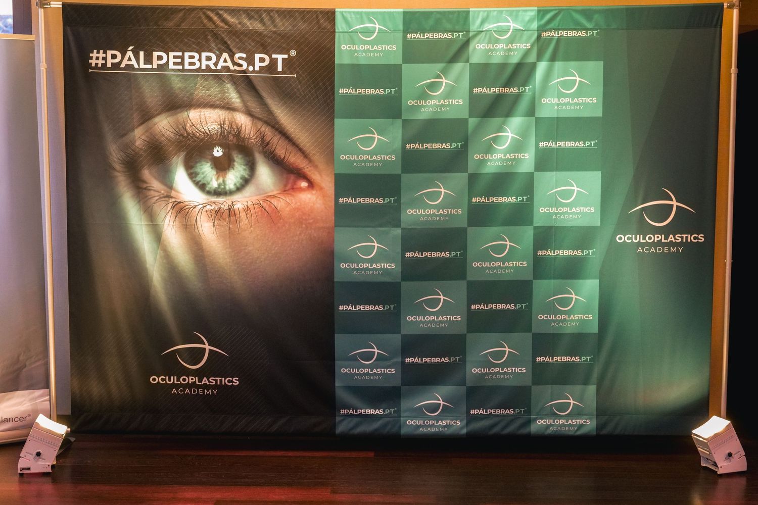 Palpebras.PT oculoplastics event backdrop banner with close-up eye graphic on display stand.