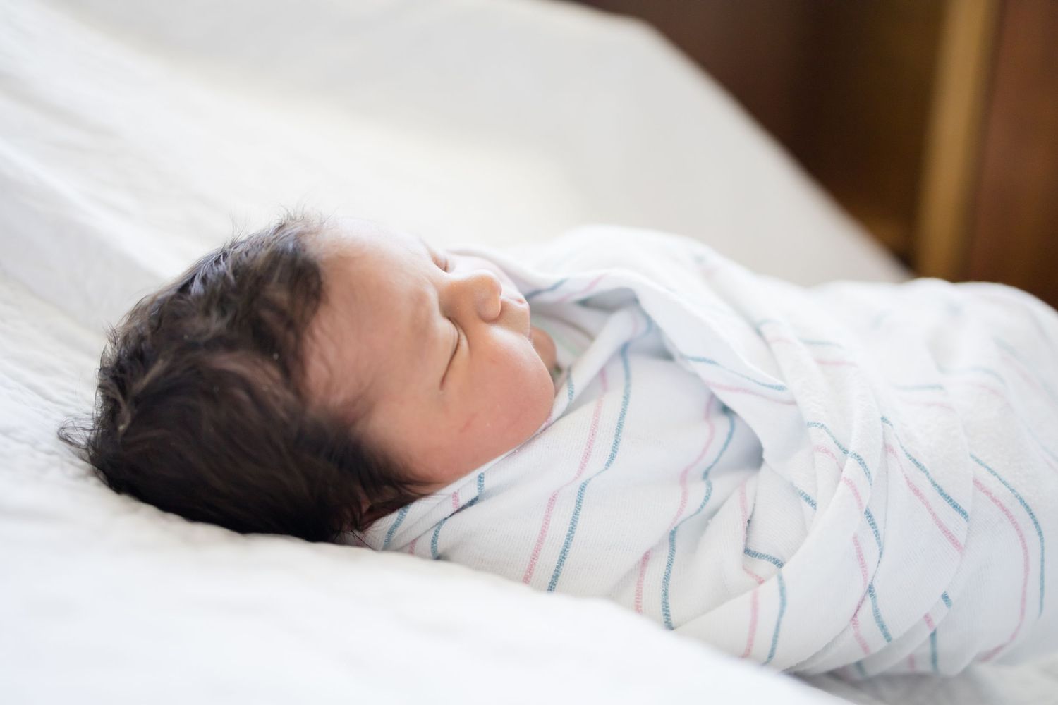 Newborn baby sleeping peacefully swaddled during her Fresh 48 session at Fort Sanders Medical Center in Knoxville.