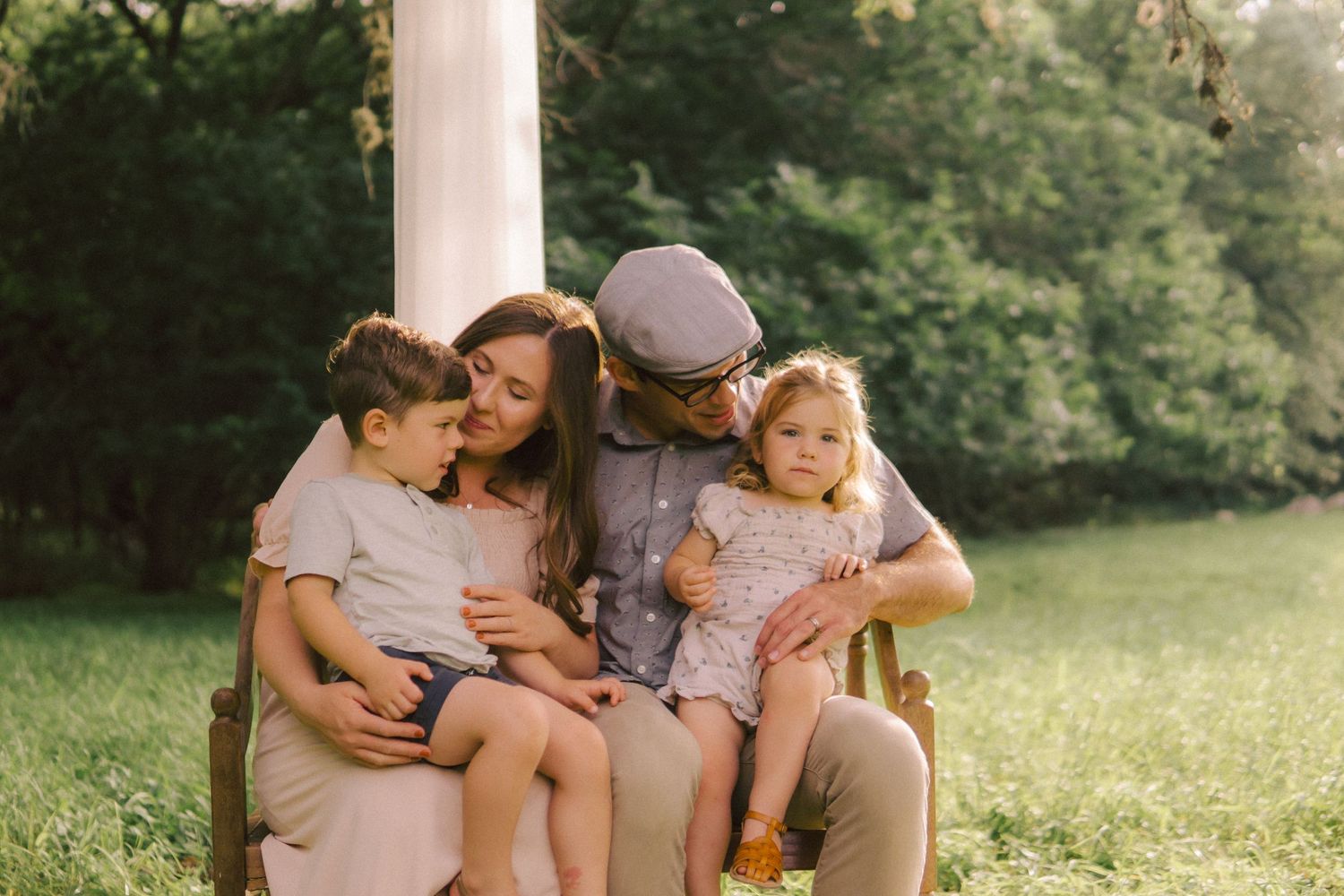 A family sits together on a in a serene outdoor setting during golden hour in South Austin.