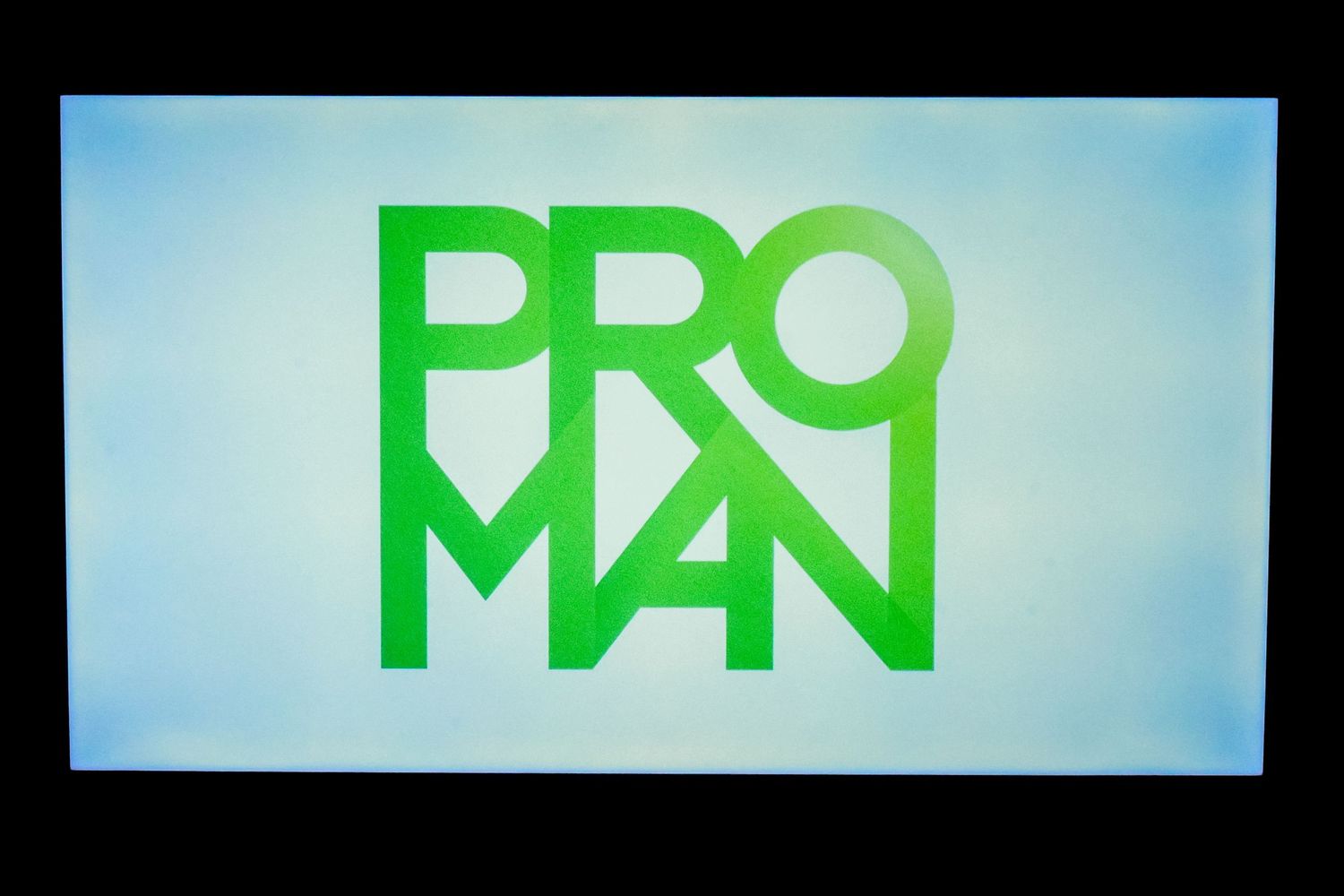 Green ProMan logo displayed on a screen against a light blue background.