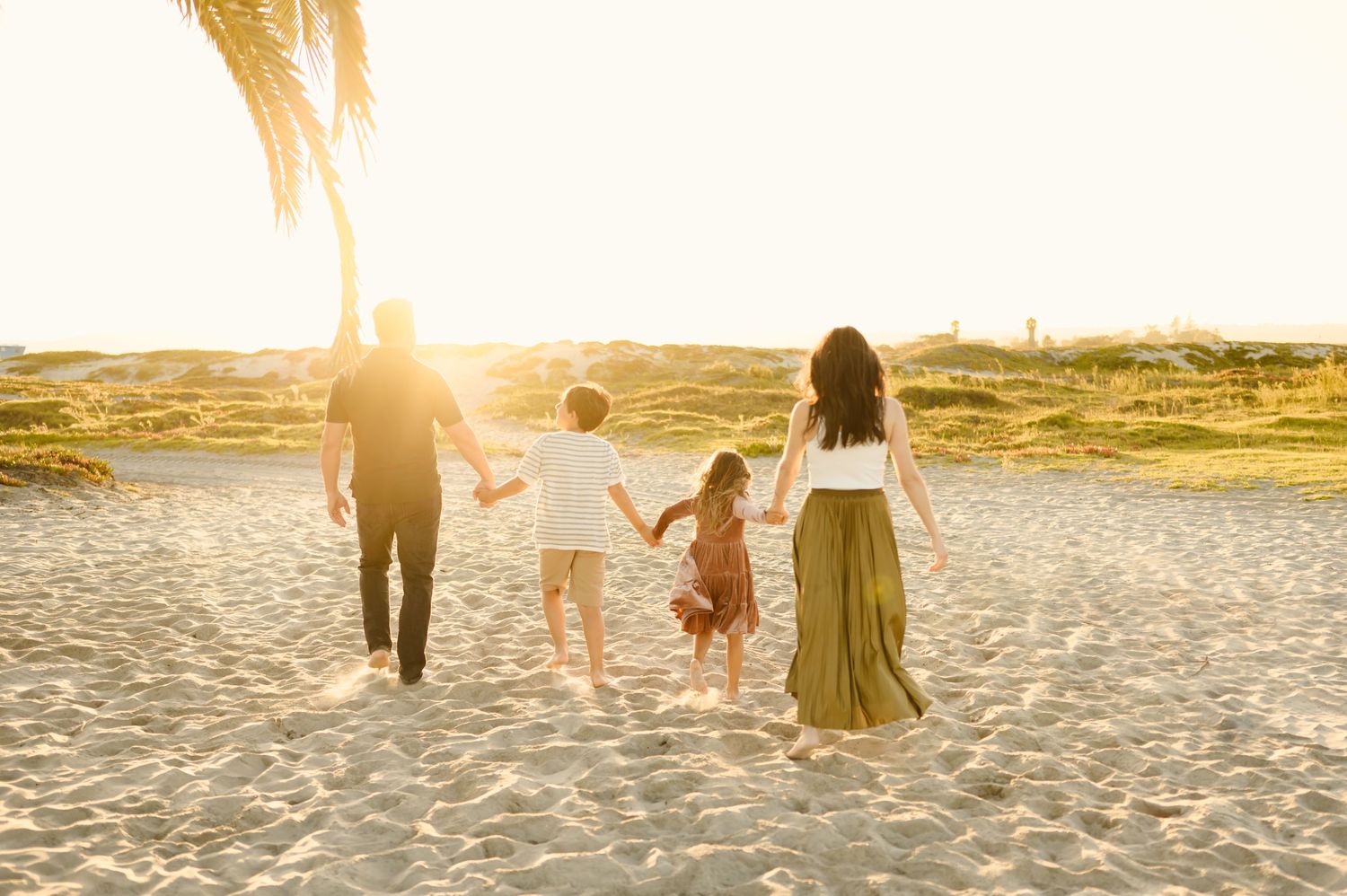 family walking together on beach during Santa Barbara family photoshoot
