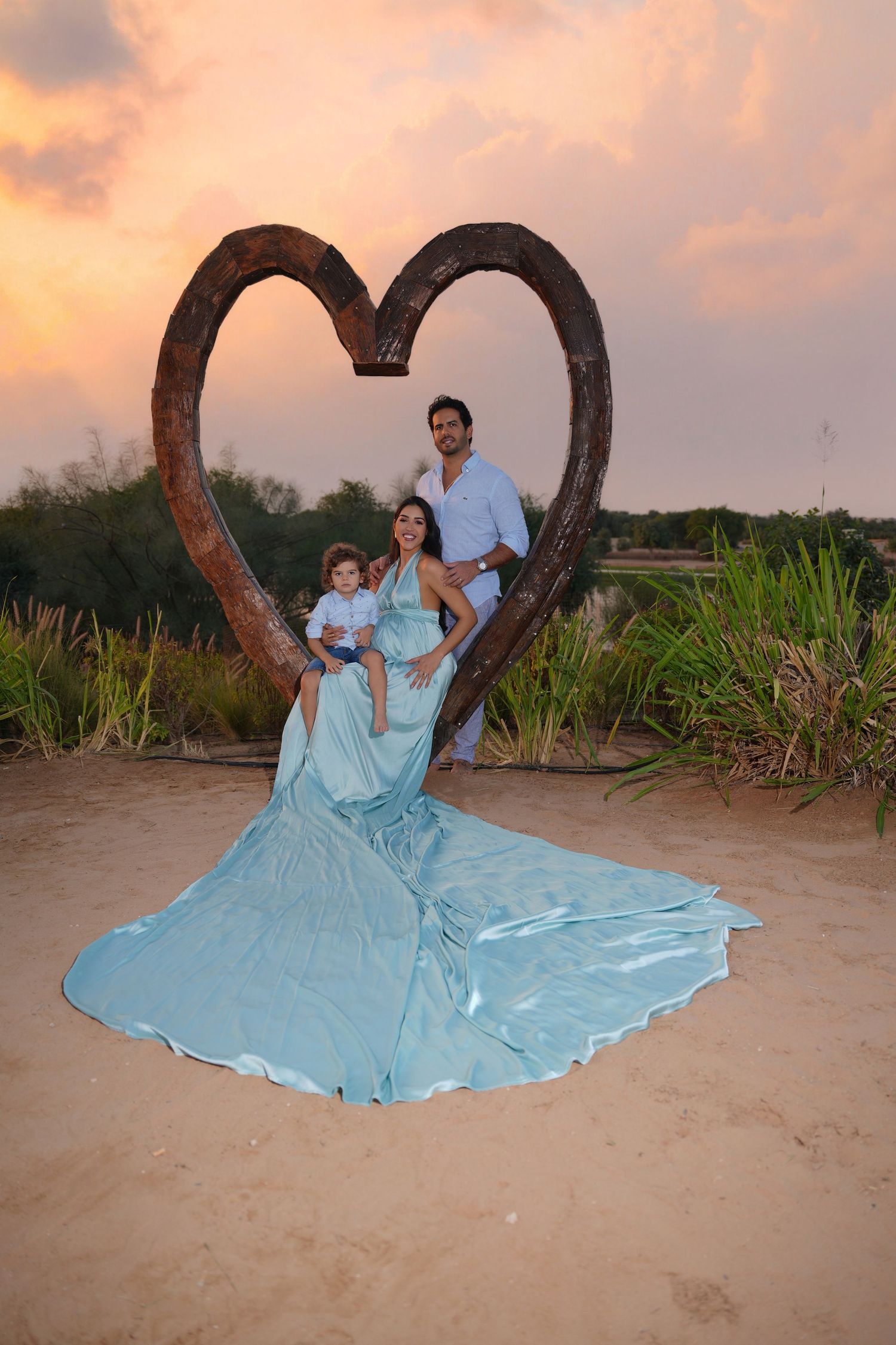 Family portrait in Dubai desert at sunset with golden dunes, captured by a family photographer Dubai for timeless, candid memories