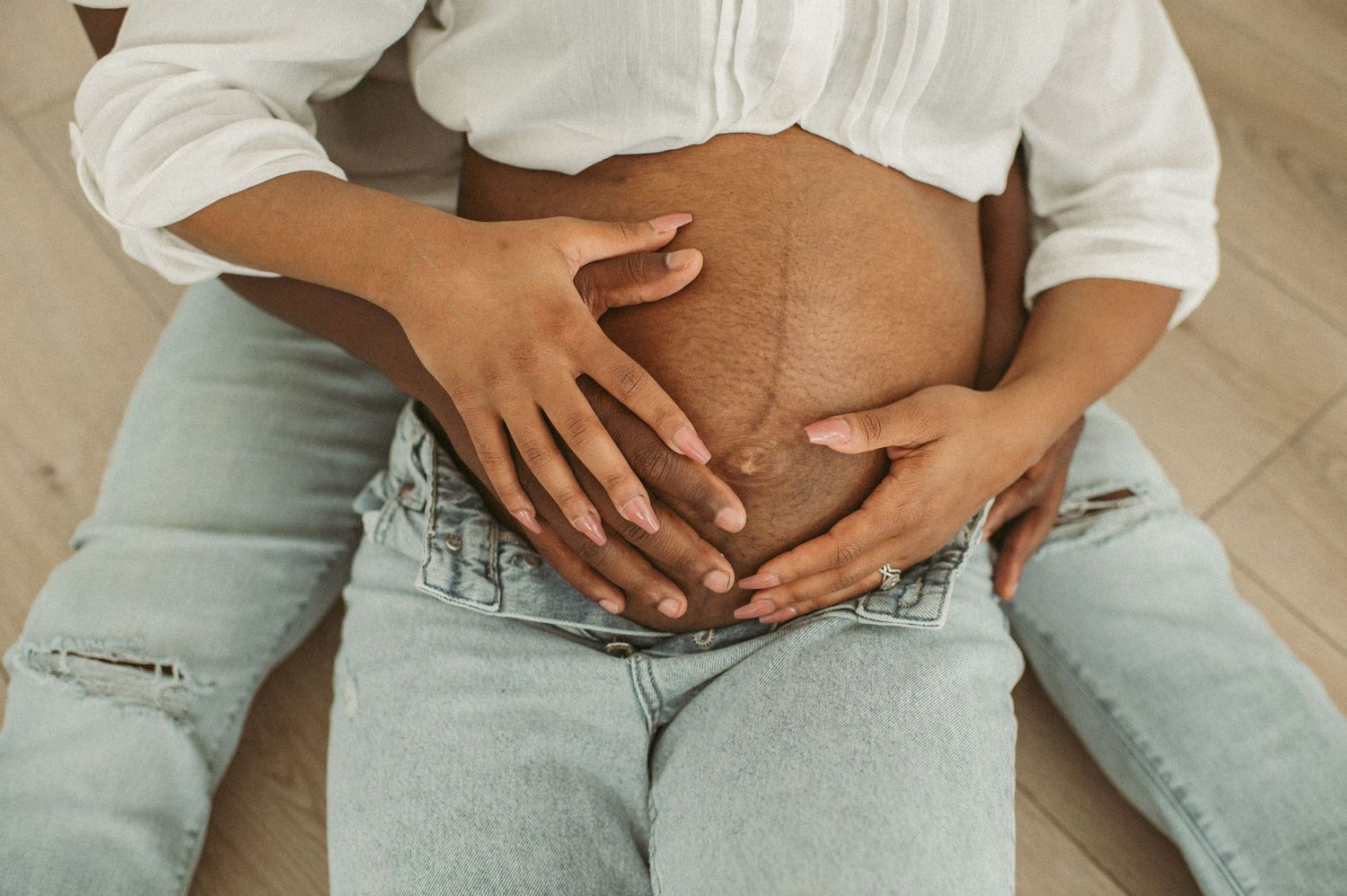 Expecting parents supporting each other while strong contractions are happening in their Chesapeake home.