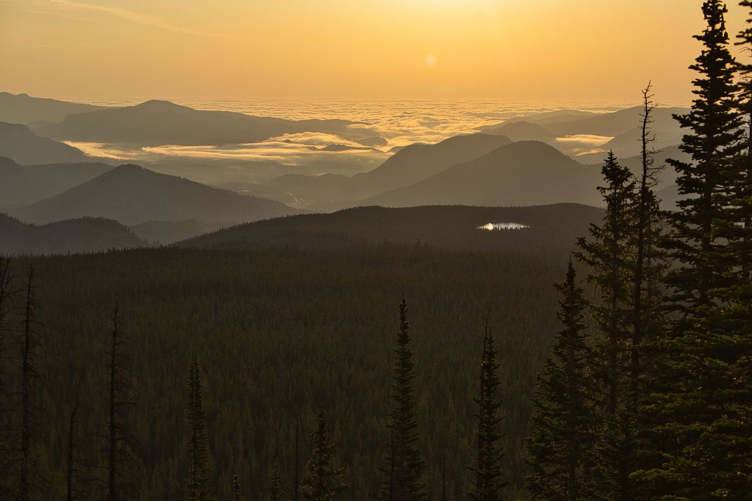 Inversion clouds and Bierstadt Lake during sunrise from the Flattop Mountain trail in Rocky Mountain National Park. Pixcapades