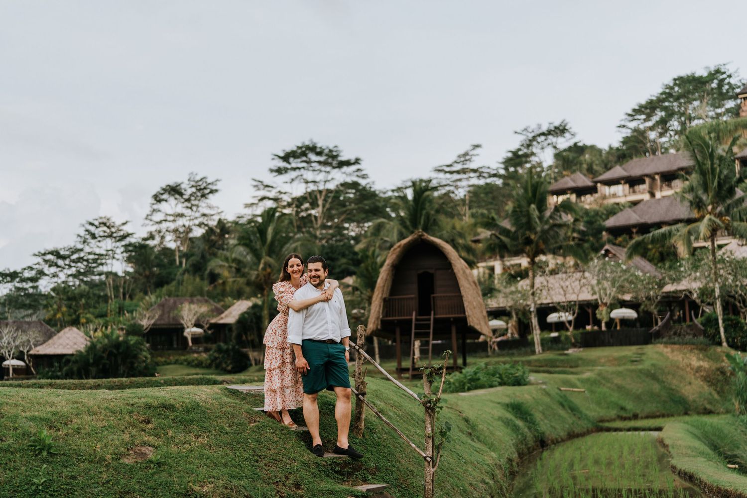 Couple sharing an intimate moment inside a rustic wooden structure with curved beams.