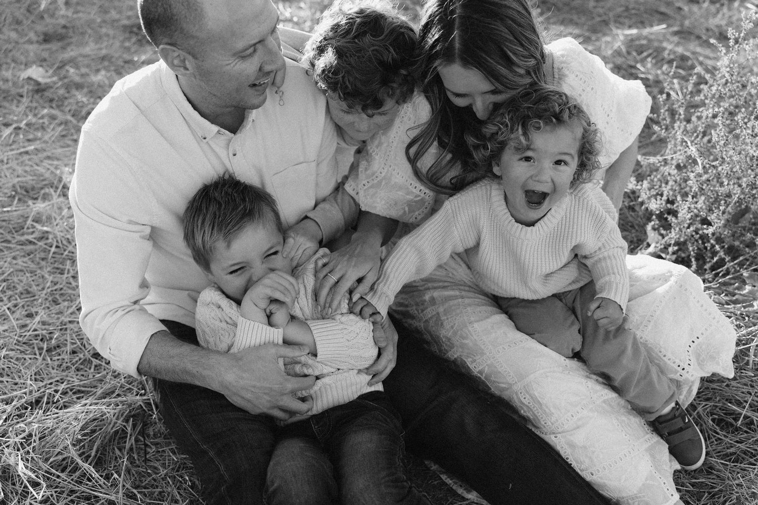 Black and white collage of intimate family moments showing affection and connection in an outdoor setting.