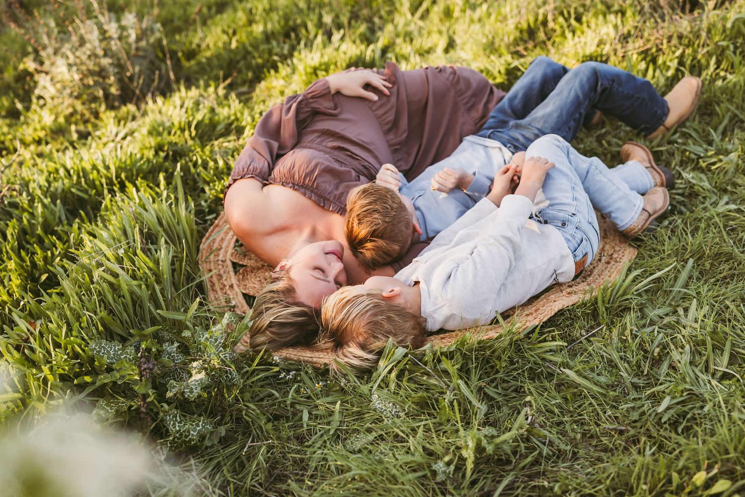 A tender moment captured in four progressive shots showing affectionate interaction with a baby wearing pink and white.