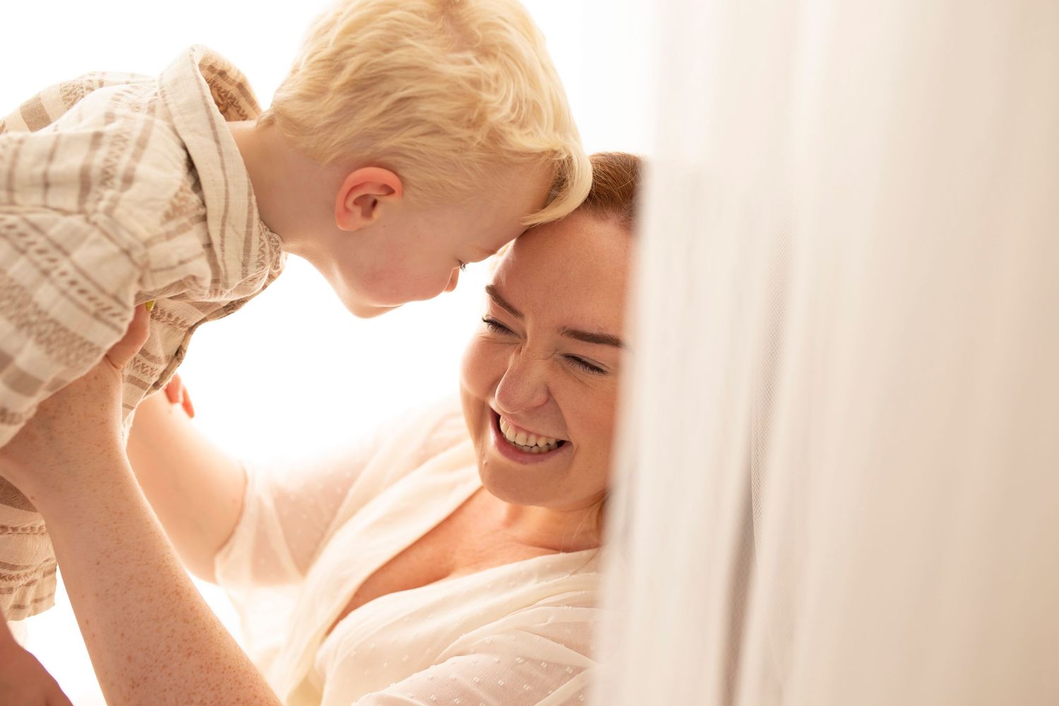 Mother and young son laughing portrait by Little Wonderland Photography Widnes Cheshire