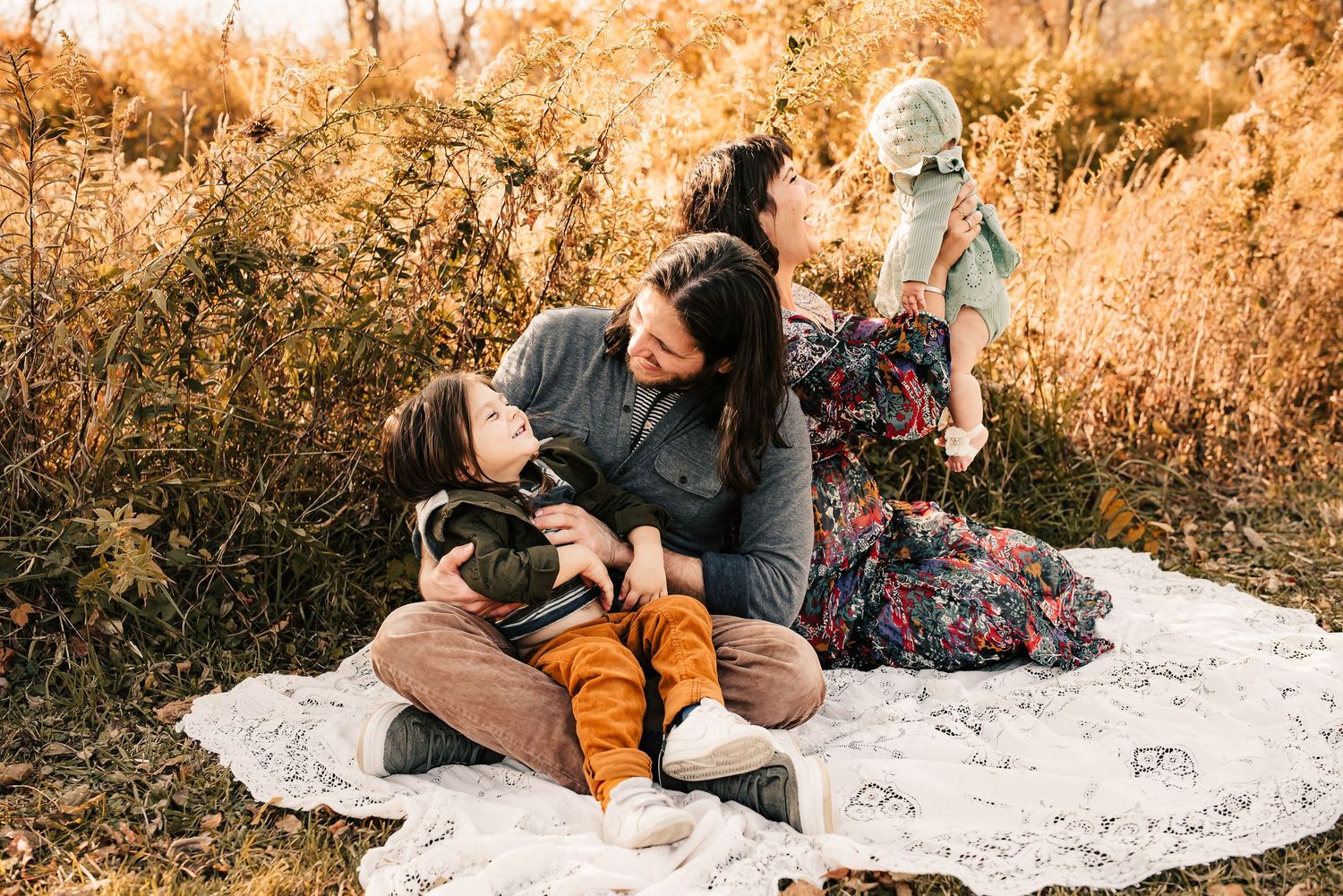 family plays together at their fall photo session in cincinnati, ohio