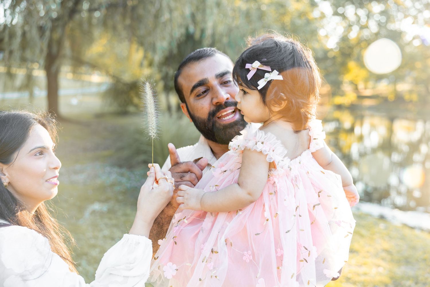Two people embrace and share a tender moment in a golden sunlit outdoor setting.