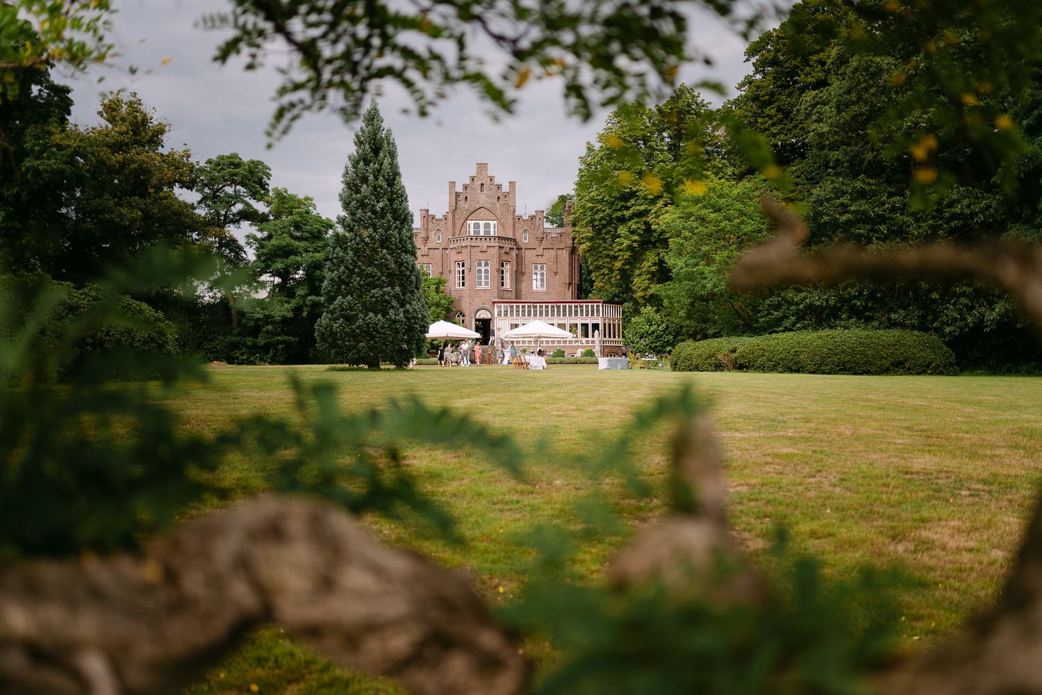 Garden view of Kasteel Aerwinkel with garden reception setup for an elegant and intimate destination wedding.