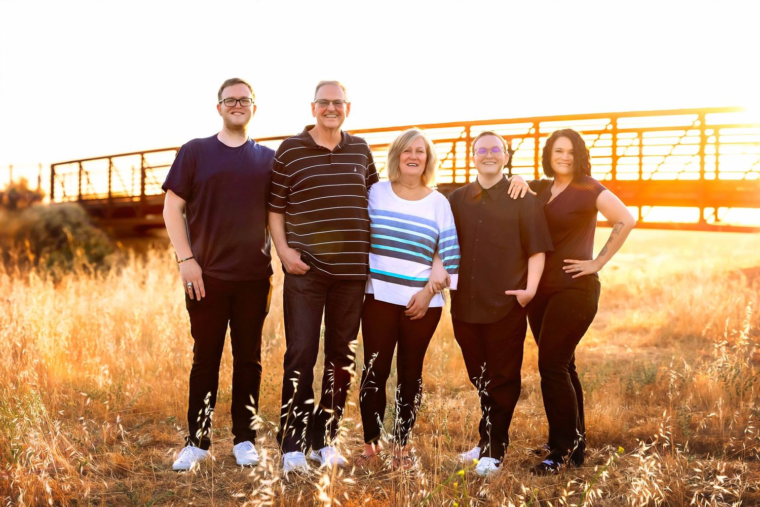 beautifully family photos with the golden hour creating that glow behind the family in fresno,ca