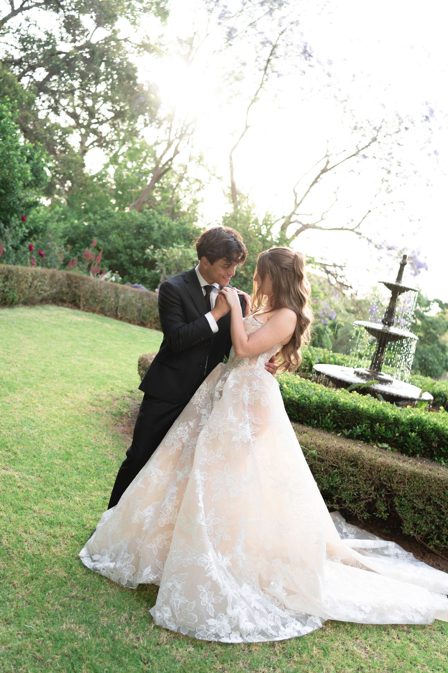 A romantic outdoor wedding photo sequence showing a couple in formal attire walking through a sunlit garden setting.