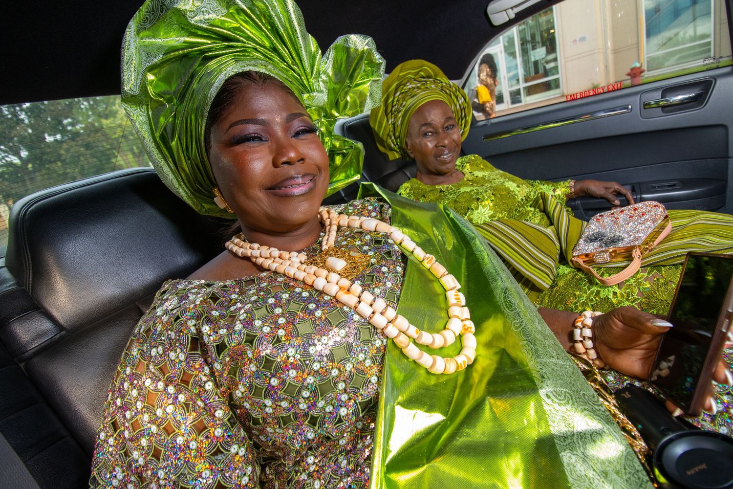 Traditional Nigerian wedding celebration with guests wearing vibrant green and yellow attire at a festive reception.