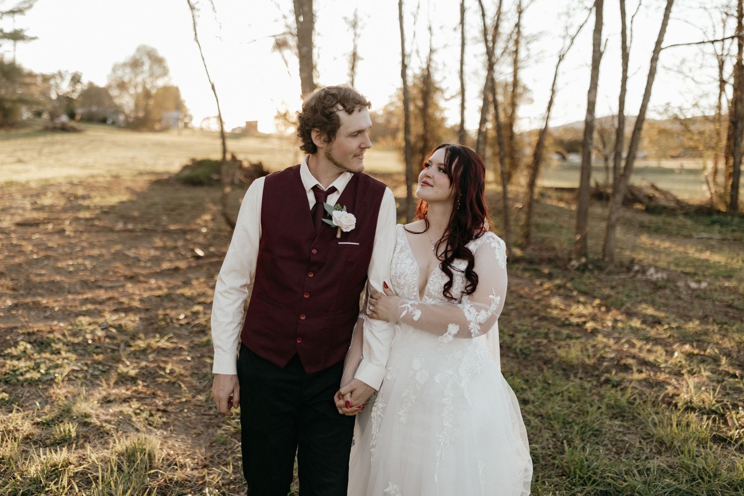 An intimate wedding portrait of a couple sharing a romantic moment outdoors.