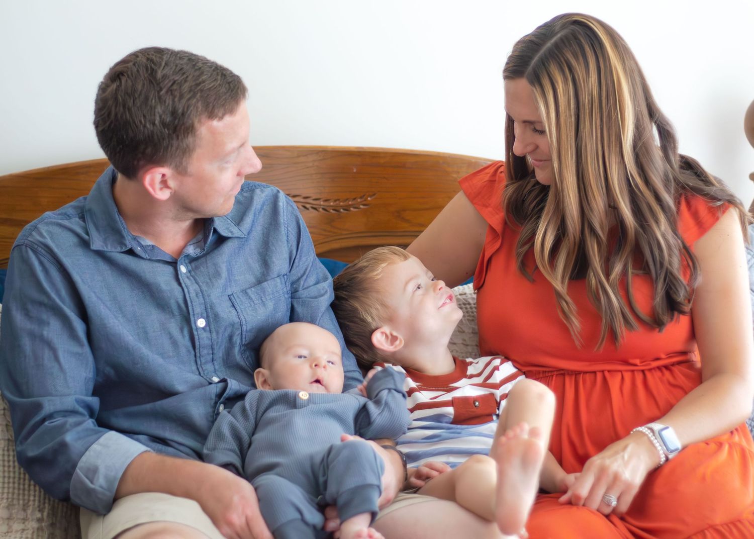 Family Lifestyle Session - Family on bed looking at each other.