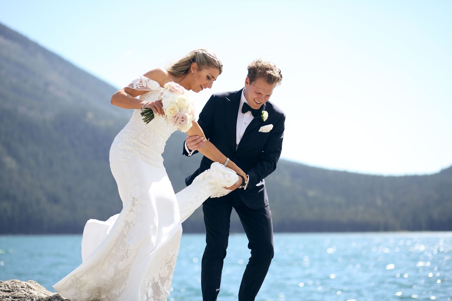 Wedding couple dances playfully by a scenic Banff mountain lake in the Canadian Rockies on an elopement photography session near Canmore