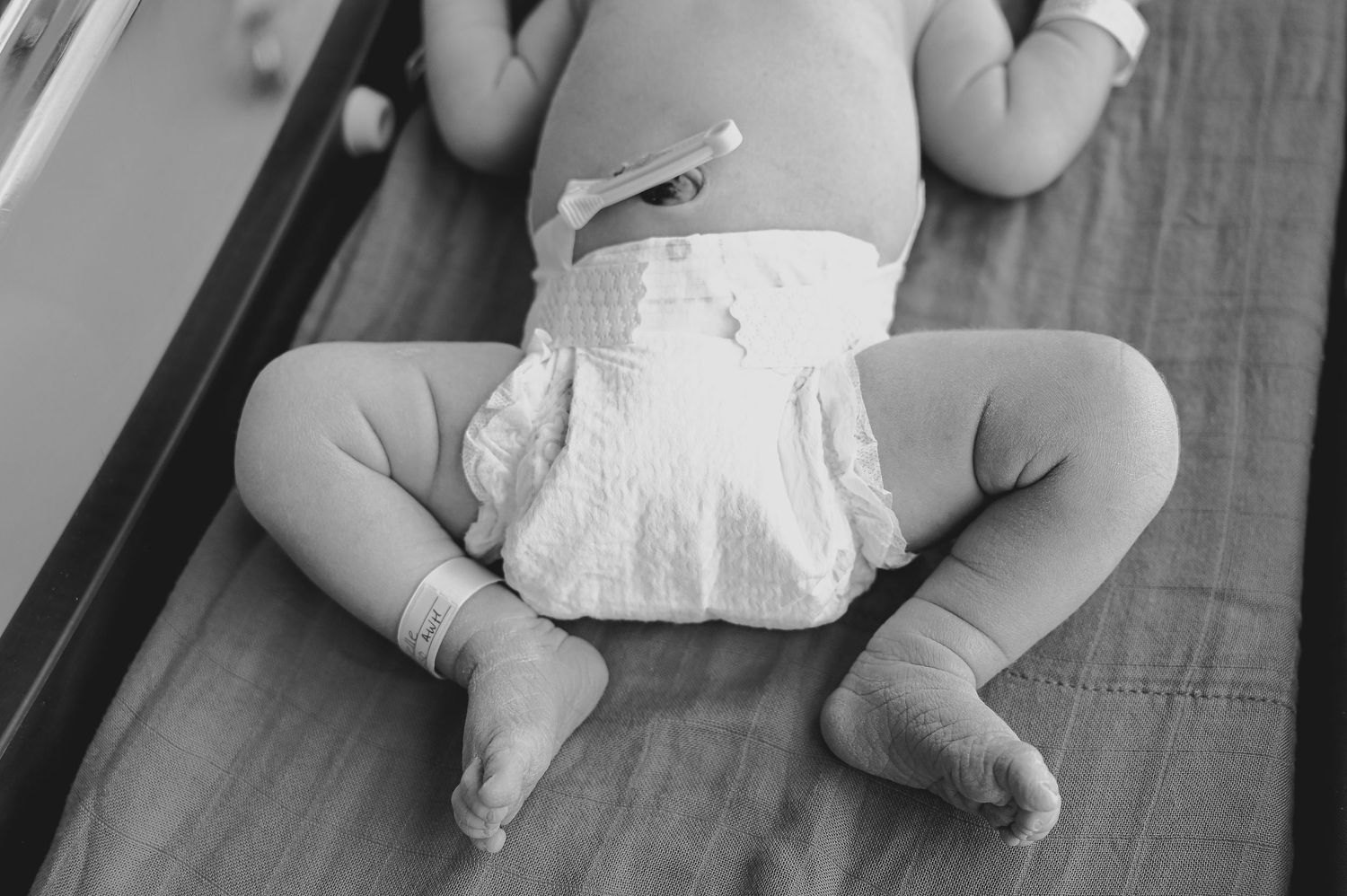 Newborn laying in fathers arms