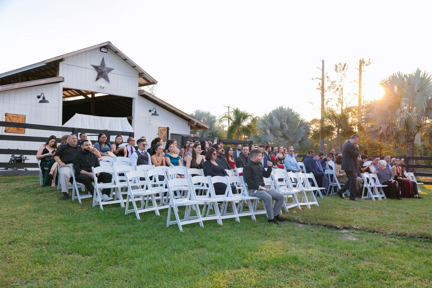 picture of the ranch 22 in lake worth wedding venue at ceremony during sunset with barn as backdrop