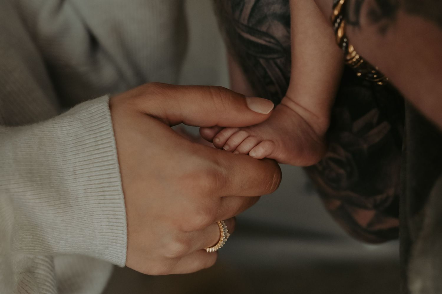 Newborn laying in fathers arms