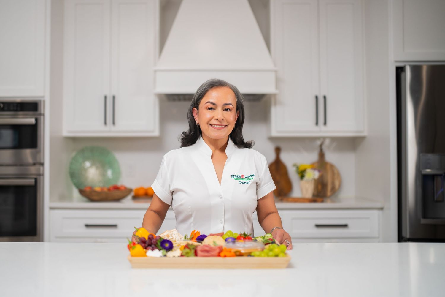 Orlando personal branding photographer Ray Alvarez — Graze Craze Lake Nona franchise owner portrait in branded white uniform in kitchen