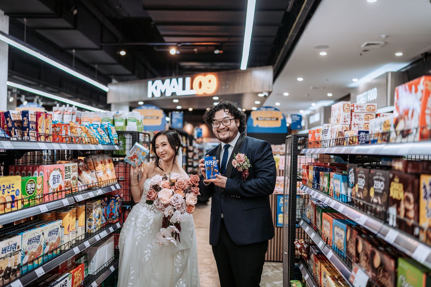 Shoppers browse products in a well-lit grocery store aisle with colorful packages and shelving displays.