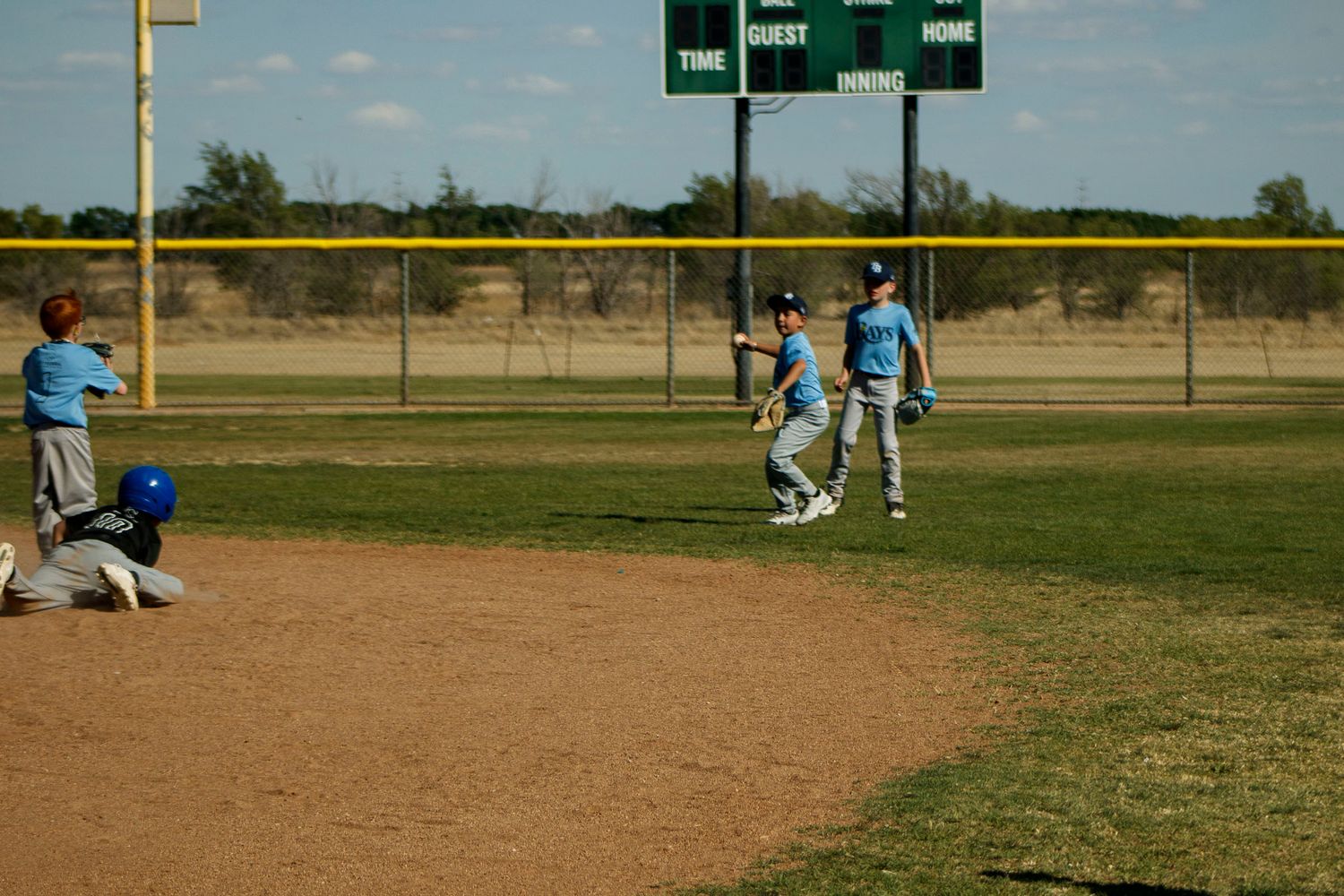 Young boys playing Little League Baseball during a sports photography session in Amarillo, Texas