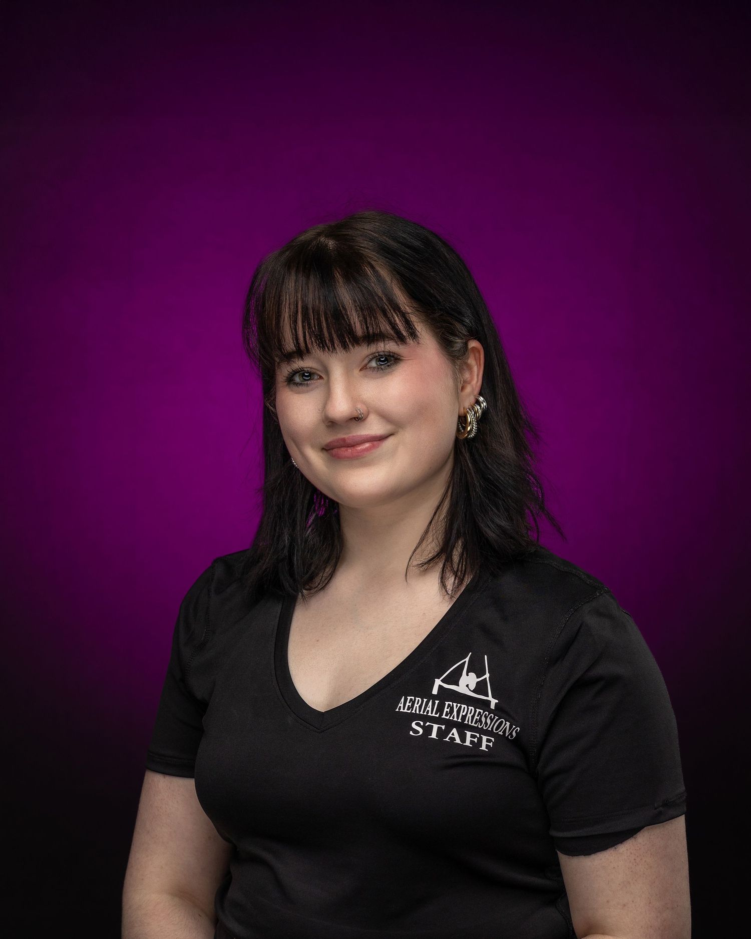 Portrait series against purple backdrop showing dramatic lighting and deep blue hair styling in Team USA athletic wear.