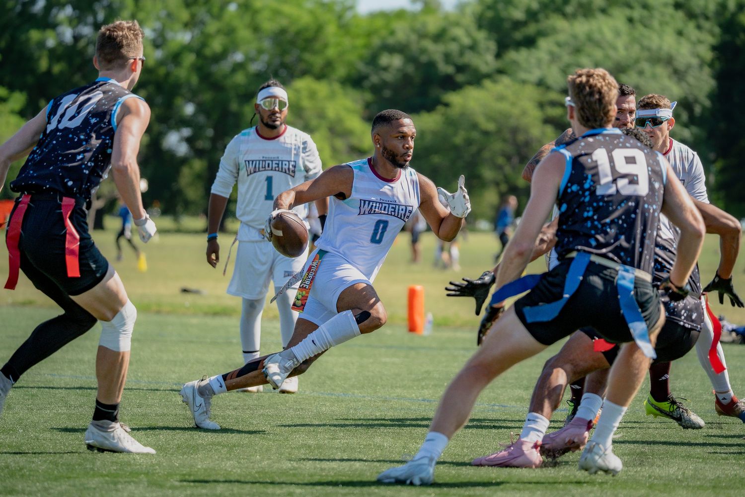 A flag football player at Pride Bowl in Chicago sprints while avoiding the Chicago Freeze