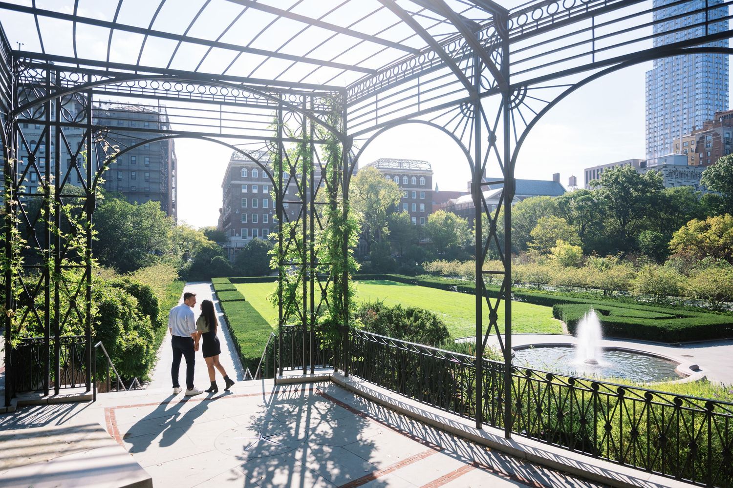 engagement session in conservatory gardens central park nyc with pergola and fountain overlooking manhattan