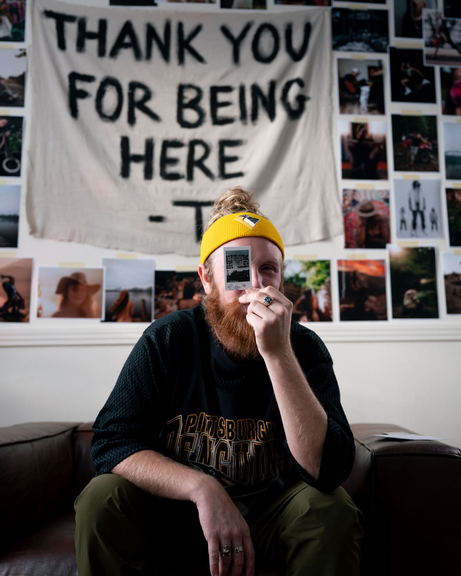 A series of black and white photos arranged on a wall with text banners reading 'THANK YOU FOR BEING HERE'.