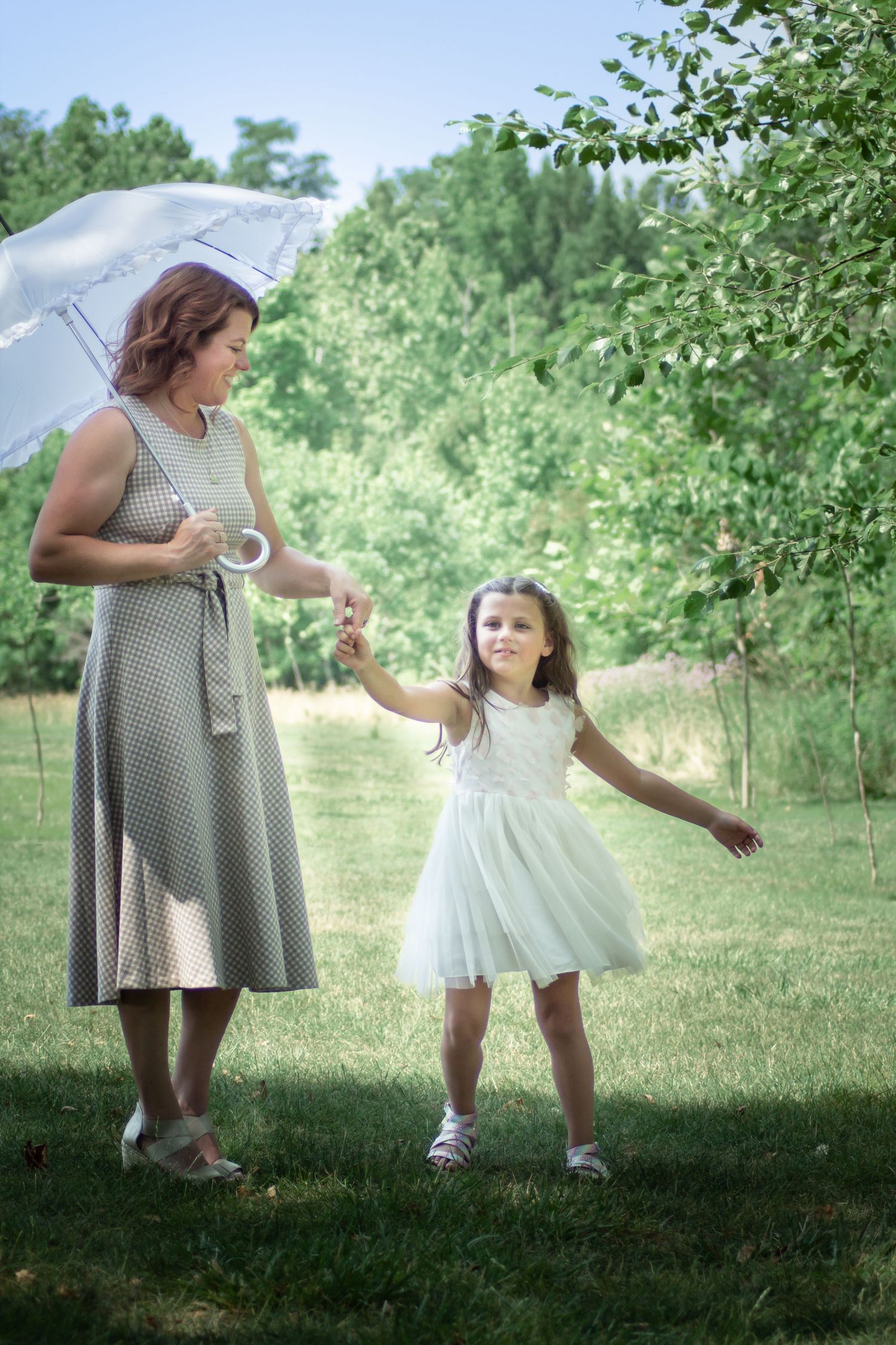 A gentle outdoor scene with umbrella on grassy field in springtime.