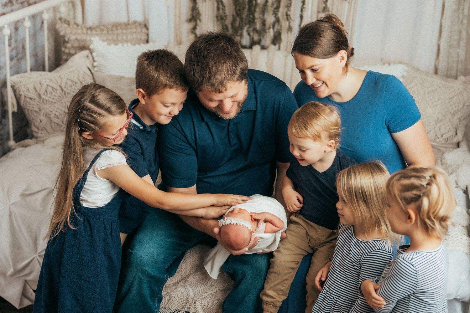Candid family moments captured showing siblings and parents interacting on a light background.